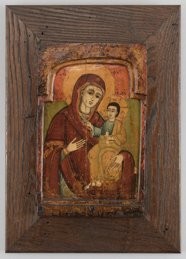 Early Greek Icon, Mother of God with wood: Greek Mother of God or Theotokos Icon, tempera on wood panel with carved arched opening enclosing the Virgin Mary with the Christ child on her lap. Later stained oak frame. 11 1/8" x 6 3/4" overall. 1
