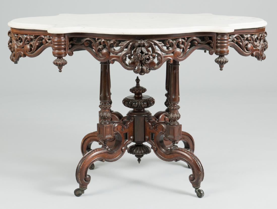 Marble Top Center Table att. Meeks: Victorian laminated, carved rosewood center table, attributed to Meeks, in the Rococo Revival to Renaissance Revival transitional style. "Turtle" shaped white marble top over a conforming foliate carv