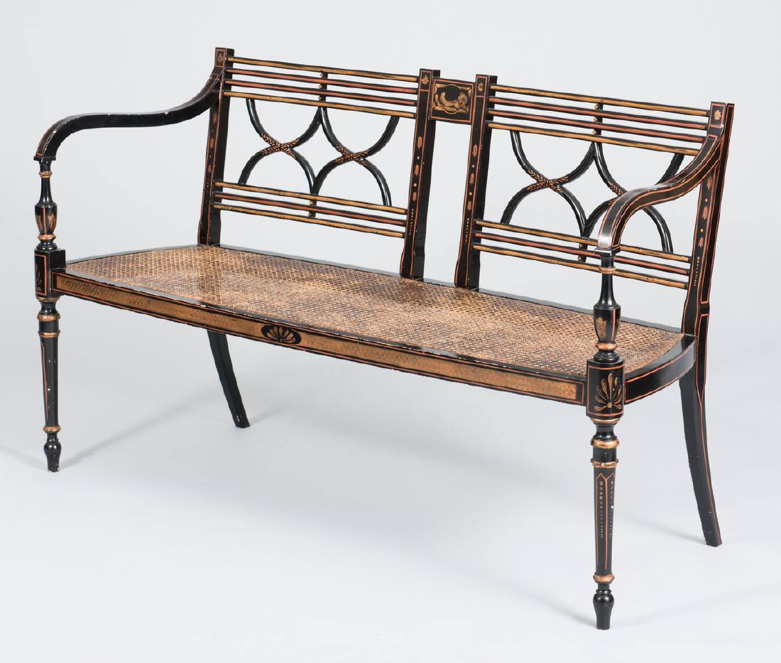 Regency Style Settee & Chair: Regency style ebonized and gilt painted settee, early 20th century, with cane seat, together with a modern 20th century Regency style ebonized and gilt painted armchair. Chair with Kindel Furniture Co