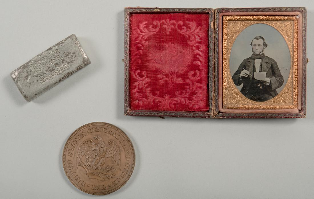 Fred Dennett Archive, inc. Tin Ingot: Ingot and archive originally belonging to Fred Dennett, 32nd Commissioner of the General Land Office, 1908-1913. 1st item: South Dakota tin ingot stamped "Nigger Hill", with Stephen F. Molitor, assaye