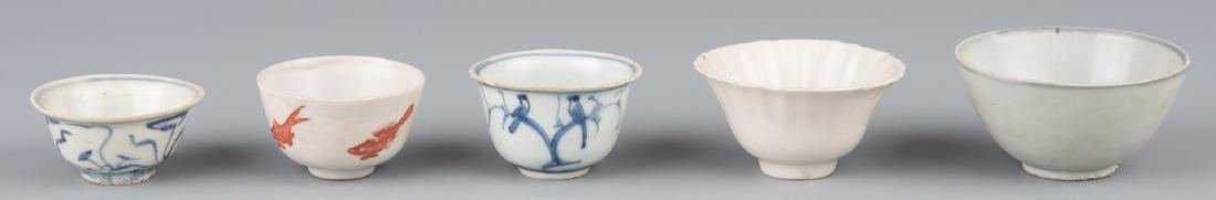 5 Asian Cups inc. Carp: 5 Asian porcelain cups including Chinese and Southeast Asian, Ming and Qing Dynasty periods. 1st item: Wine cup with exterior iron red decoration of carp, interior with sancai type glaze wheel design,