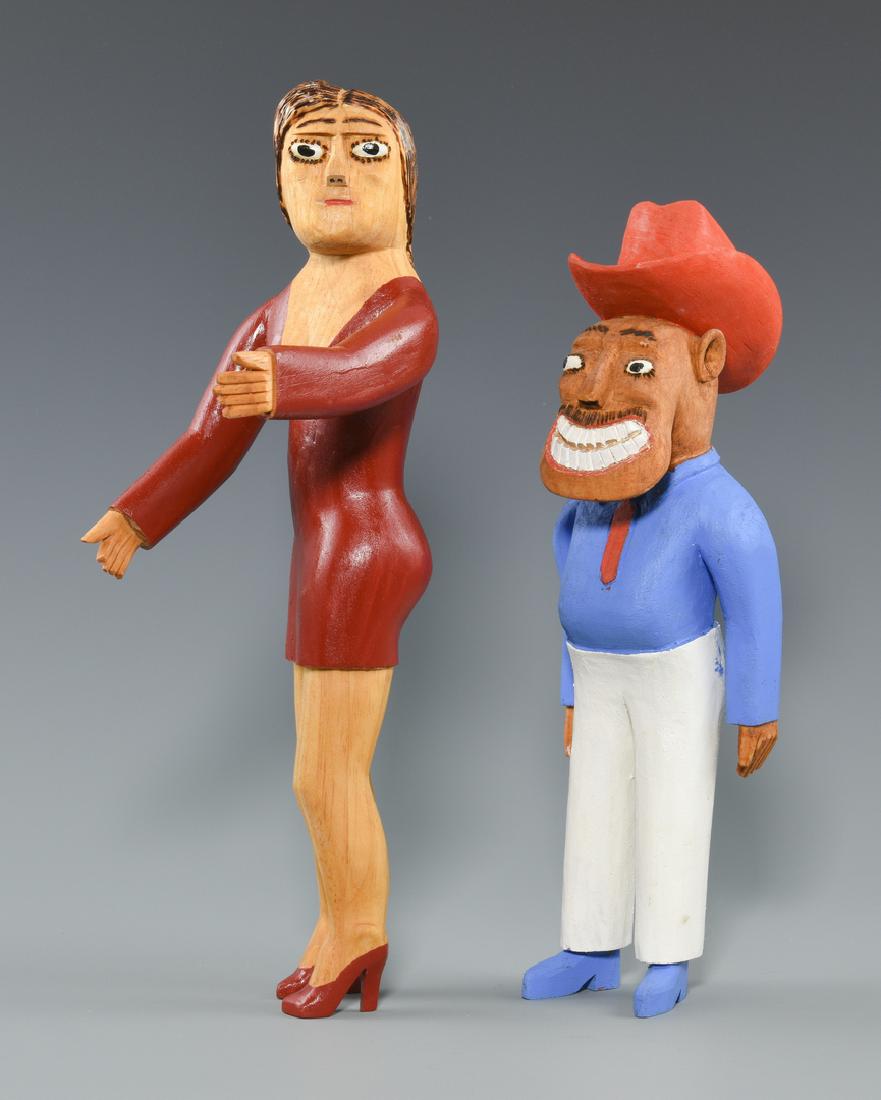 2 Sulton Rogers Carvings, Man and Woman: Two (2) Sulton Rogers (Mississippi, 1922-2003) painted wood folk art carvings including a man in a red cowboy hat and a woman in a red dress. Female carving signed "S R" on bottom of heels. Carvings r