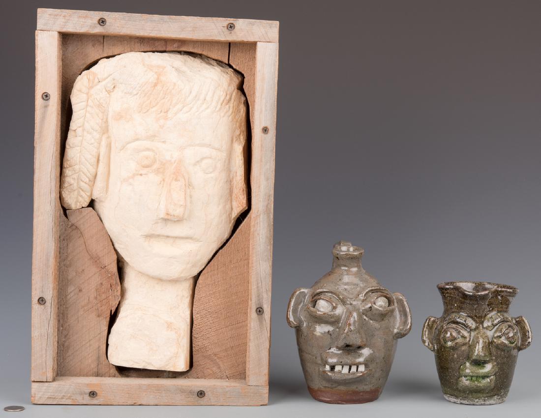 2 Burlon Craig Folk Art Pottery Items and 1 Clay Head: Two North Carolina folk pottery items by Burlon Craig (North Carolina, 1914-2002) and one attributed clay carving. 1st item: Folk art pottery face Jug with green glaze, open mouth and a single row of 