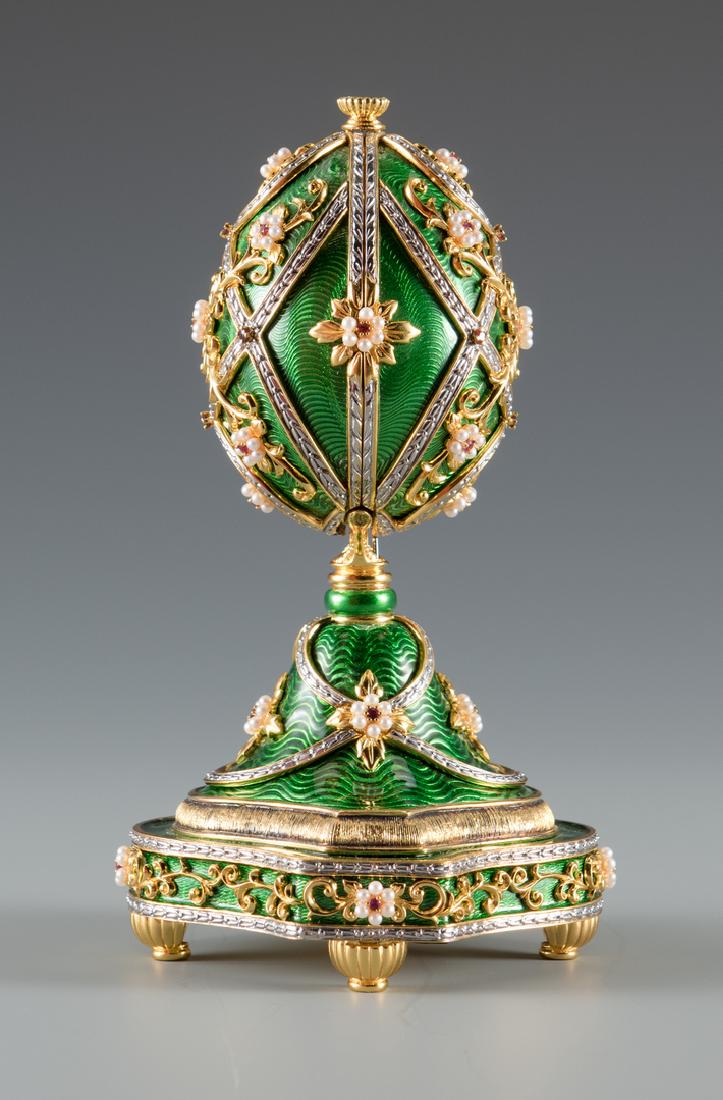 Franklin Mint Faberge Egg Music Box: Franklin Mint House of Faberge egg music box, 24 K gold on sterling silver with green guilloche enamel decoration, accented by seed pearl and ruby "flowers", marked on underside "The Garden of Jewels