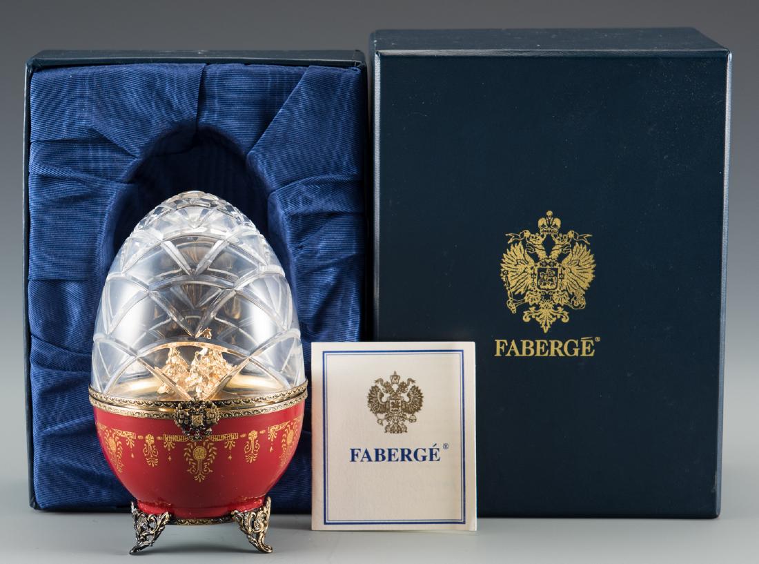 Faberge Limoges Christmas Egg: House of Faberge Limoges limited edition red porcelain and crystal egg with original blue Faberge box and signed and numbered certificate. Cut crystal hinged dome top opening to reveal a gilded interi