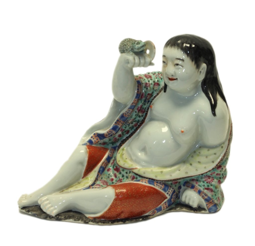 Chinese famille rose porcelain liu hai, Republican: modeled wearing vibrant colored loose robes open at the chest, reclining with a toad seated on his raised right hand; Wei Hong Tai seal mark on bottom, 9.65in(L) x 7.87in(H)