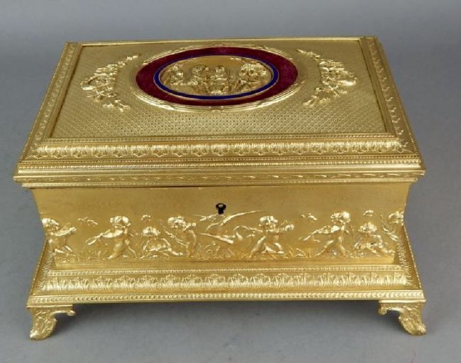 19TH CENTURY DORE BRONZE JEWELLRY BOX: Decorated with cherubs, birds and butterflies around the sides, hinged lid has figural scene with porcelain ring, fabric lined inside, four feet and measures 5" x 9" x 6 1/4". Estimate $600-800