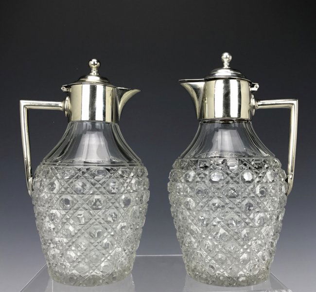 A PAIR OF SILVER PLATED AND CUT CRYSTAL CARAFES (1 of 2)