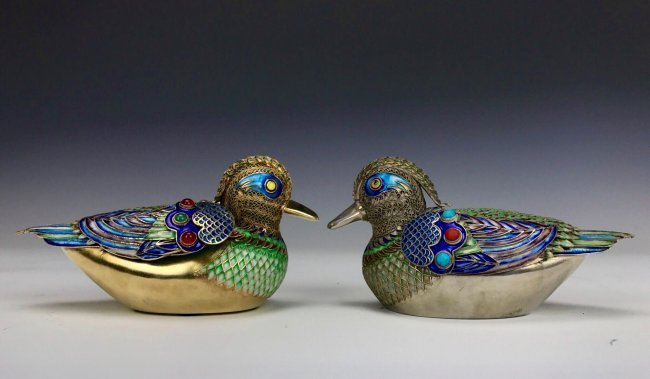 A PAIR OF CHINESE SILVER & ENAMEL DUCKS: Inset with carpal and tourquoise, measuring 6.5" Long. Weighing 650 grams. Excellent condition. Estimate $1.500-2.000