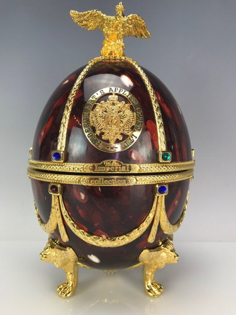 IMPERIAL HOUSE FABERGE VODKA SET: Gilt with 24Kt and inset with semiprecious stones. Inside Faberge crystal bottle and shot glasses. Estimate $1.500-2.000