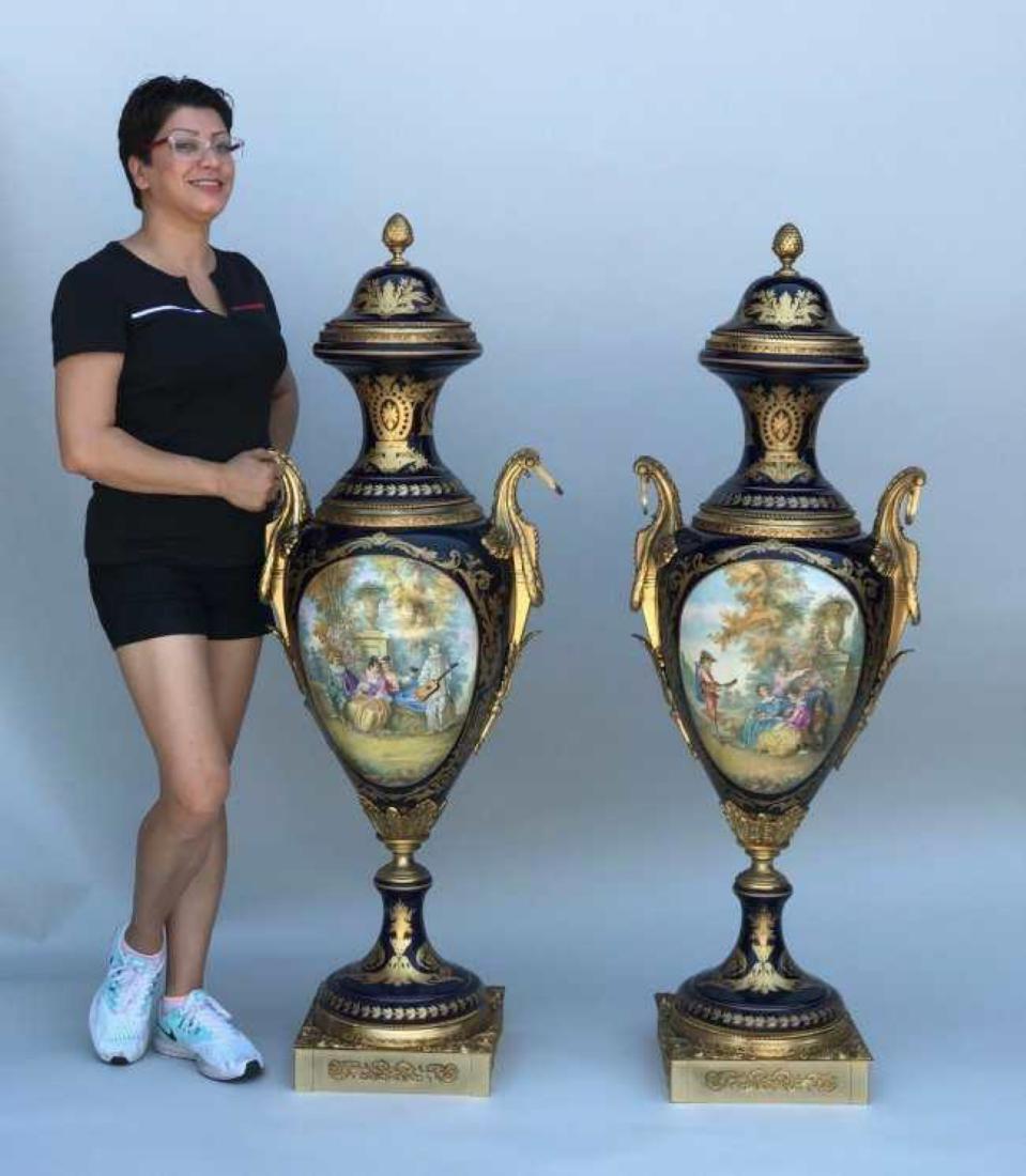 PALATIAL PAIR OF ORMOLU MOUNTED SEVRES VASES: Measuring 56" High. Excellent condition. Estimate $6.000-8.000