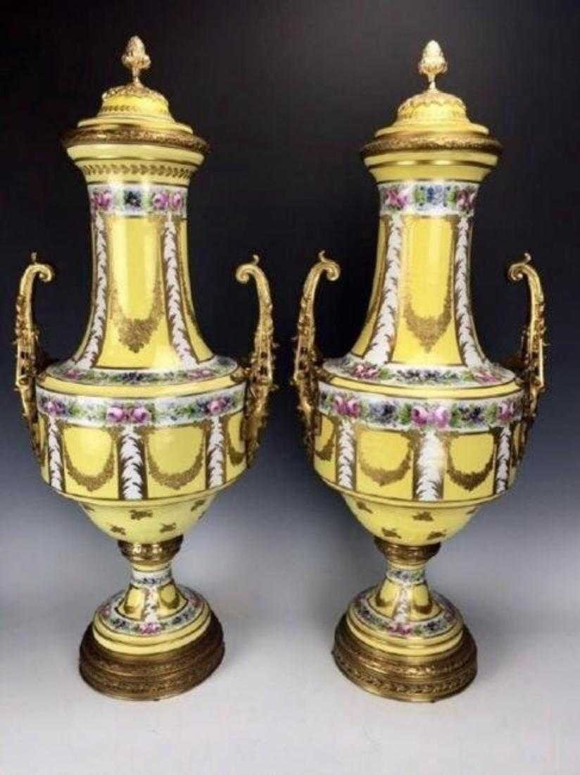 PAIR OF ORMOLU MOUNTED SEVRES STYLE PORCELAIN VASES: Circa 1900. Measuring 33.5" High. Estimate $5.000-6.000