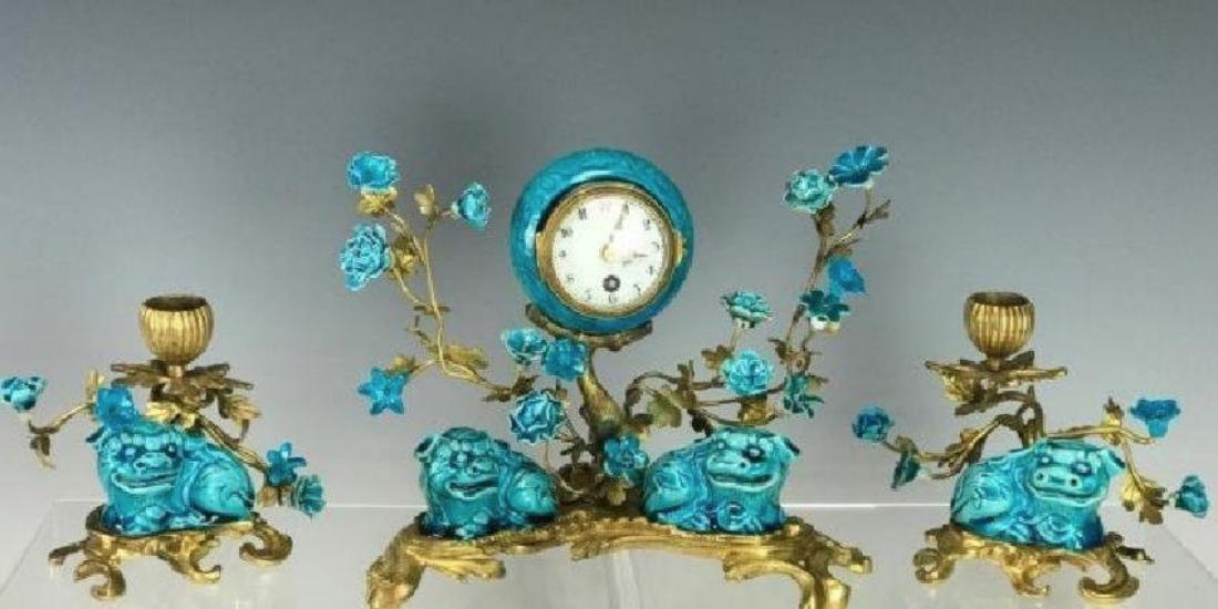19TH C. CHINESE PORCELAIN AND DORE BRONZE CLOCK SET: 19th. C. French Chinoiserie Clock Set, marked. Clock: 7 1/4 H x 8 W x 5 3/8 D, Candlesticks: 4 3/8 D. Estimate $2.500-3.000
