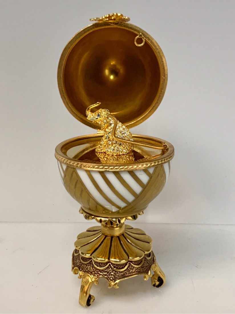 FABERGE 24KT GOLD OVER SILVER JEWELED ELEPHANT EGG: Signed Faberge, Limoges France. FABERGE stamp and 925 stamp. Good condition. Estimate $700-800