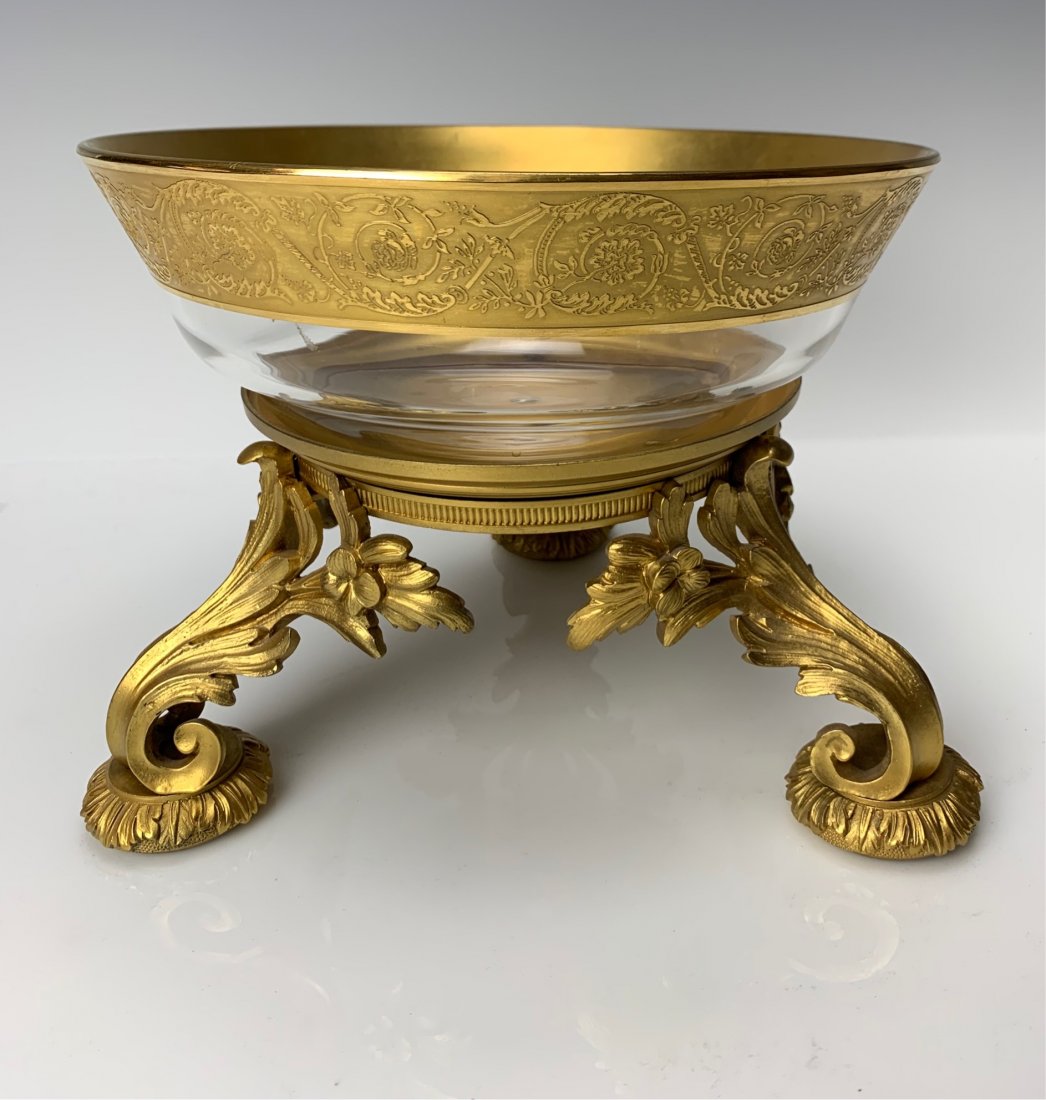 A LARGE DORE BRONZE AND GILT BACCARAT GLASS CENTERPIECE: Circa 1900. Measures 9 inches d. Good condition. Estimate $1000-1.200