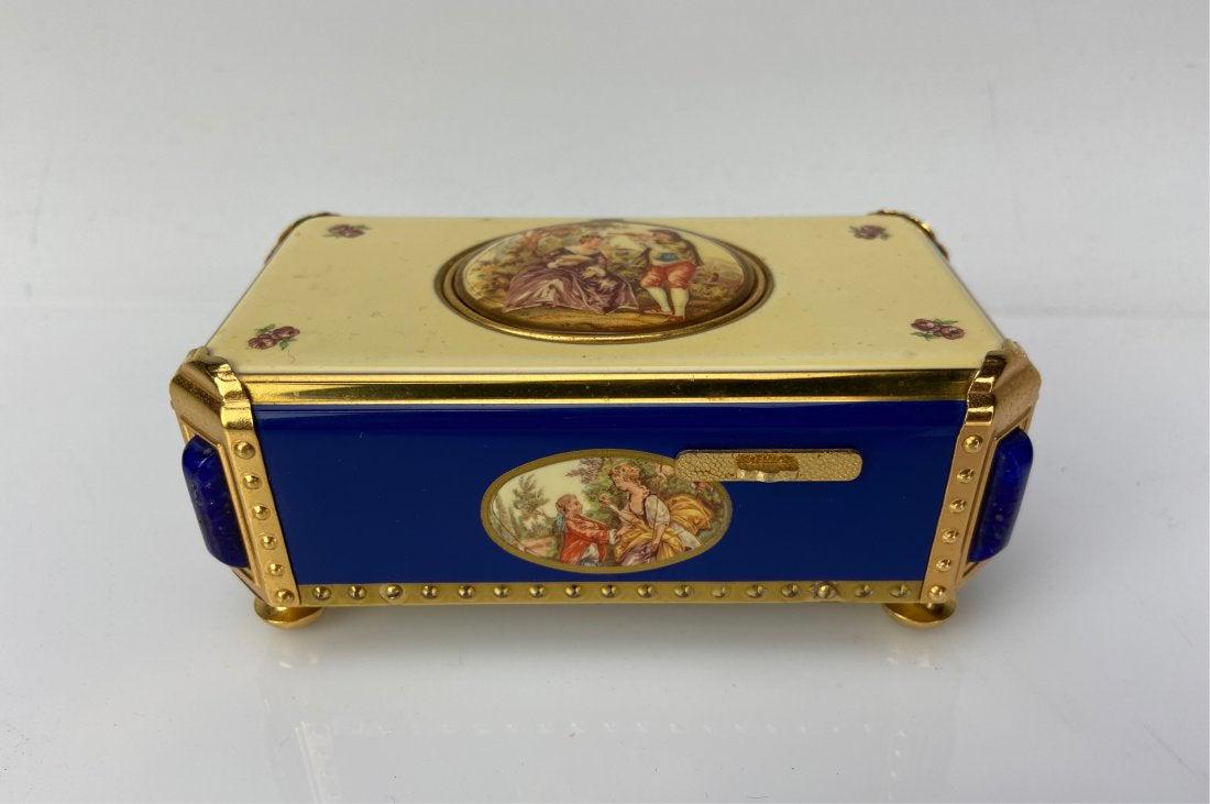 SWISS ENAMEL AND LAPIS AUTOMATON MUSIC BIRD BOX: Made by Reug. Measures 6.5 inches long. In good working condition. Estimate $3.000-3.500