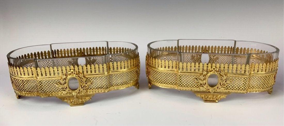 A PAIR OF ORMOLU AND BACCARAT CENTERPIECES: Circa 1900. Measure 10 inches long. Good condition. Estimate $1.000-1.200