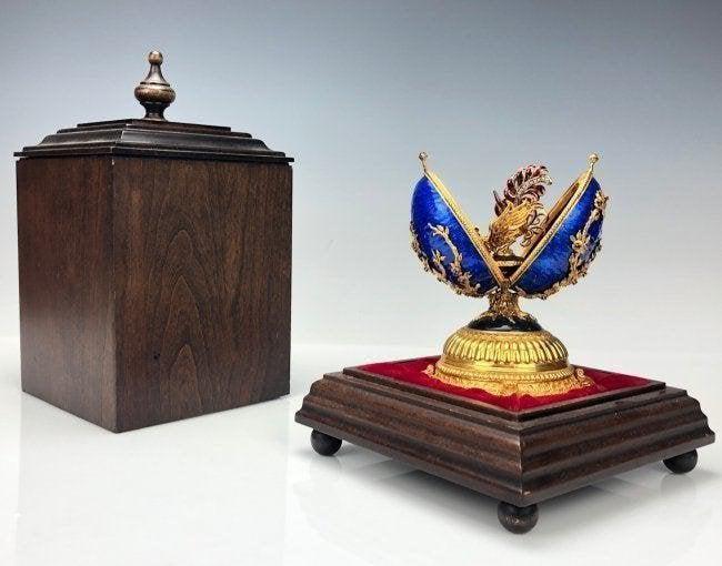 IMPERIAL FABERGE SILVER AND ENAMEL MUSICAL EGG: Faberge Imperial Jeweled Musical Egg, 150th Anniversary. Sterling Silver, and enamel inset with rubies . With a 18KT gold and enamel pin as the surprise. With original box. Estimate $3,500-4.000