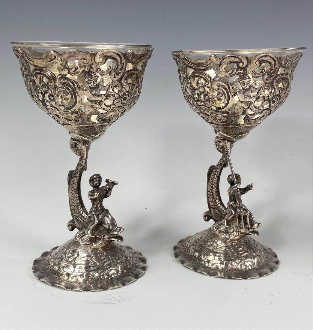 A PAIR OF CONTINENTAL SILVER FIGURAL SALTS: Circa 1880. With glass liners. Hallmarked. Measure 7.5 inches high. Estimate $800-1.000