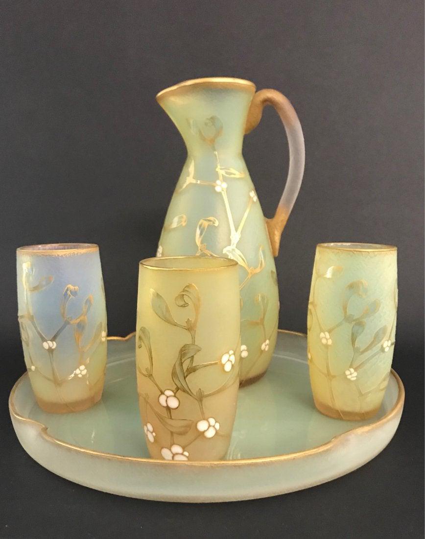 AN ENAMELED DAUM NANCY ACID WASHED LIQUOR SET: Circa 1905. Ewer 10 inches high. All pieces in good condition. Estimate $1.500-2.000