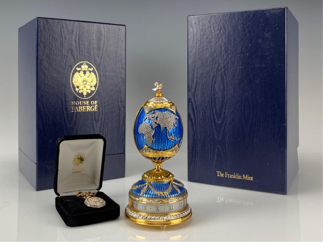 VERY RARE JEWELED STERLING SILVER FABERGE EGG: Titled : "PEACE ON EARTH MILLENIUM COMMEMORATIVE EGG" . Gold over silver silver and jeweled , with a rotary clock and a pin clock. The egg is inscribed with the Faberge Cyrillic "F". Crowning the egg