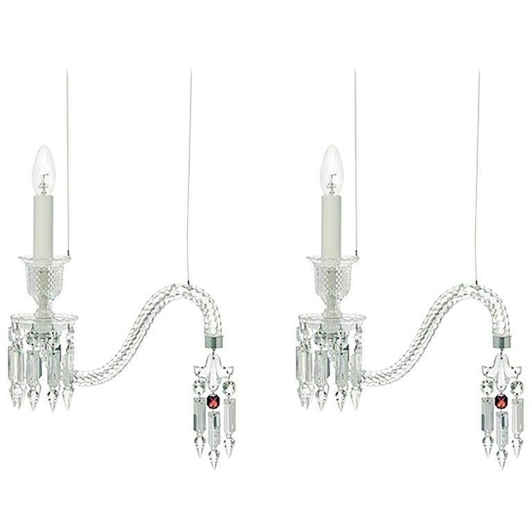 A PAIR OF FANTOME BACCARAT PENDANT LIGHTS: A pair of handcrafted full-lead crystal Fantome pendant lights designed by Arik Levy for Baccarat. Hung from silver metal ceiling mount as shown. Drop height can be adjusted. Estimate $4.000-5.000