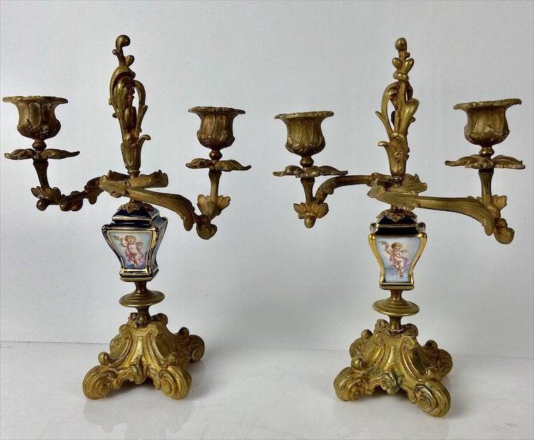 A PAIR OF DORE BRONZE AND SEVRES PORCELAIN CANDELABRA: Circa 1900. Measure 9 inches high. Good condition. Estimate $600-800