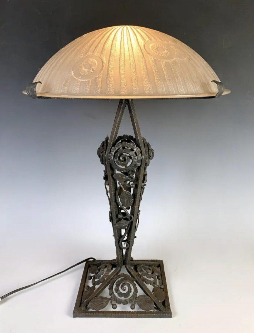 A LARGE WROUGHT IRON WITH DAUM NANCY SHADE LAMP: Signed Daum Nancy. Measures 23 inches high, 16 inches diameter. In good antique condition.Estimate $2.500-3.000