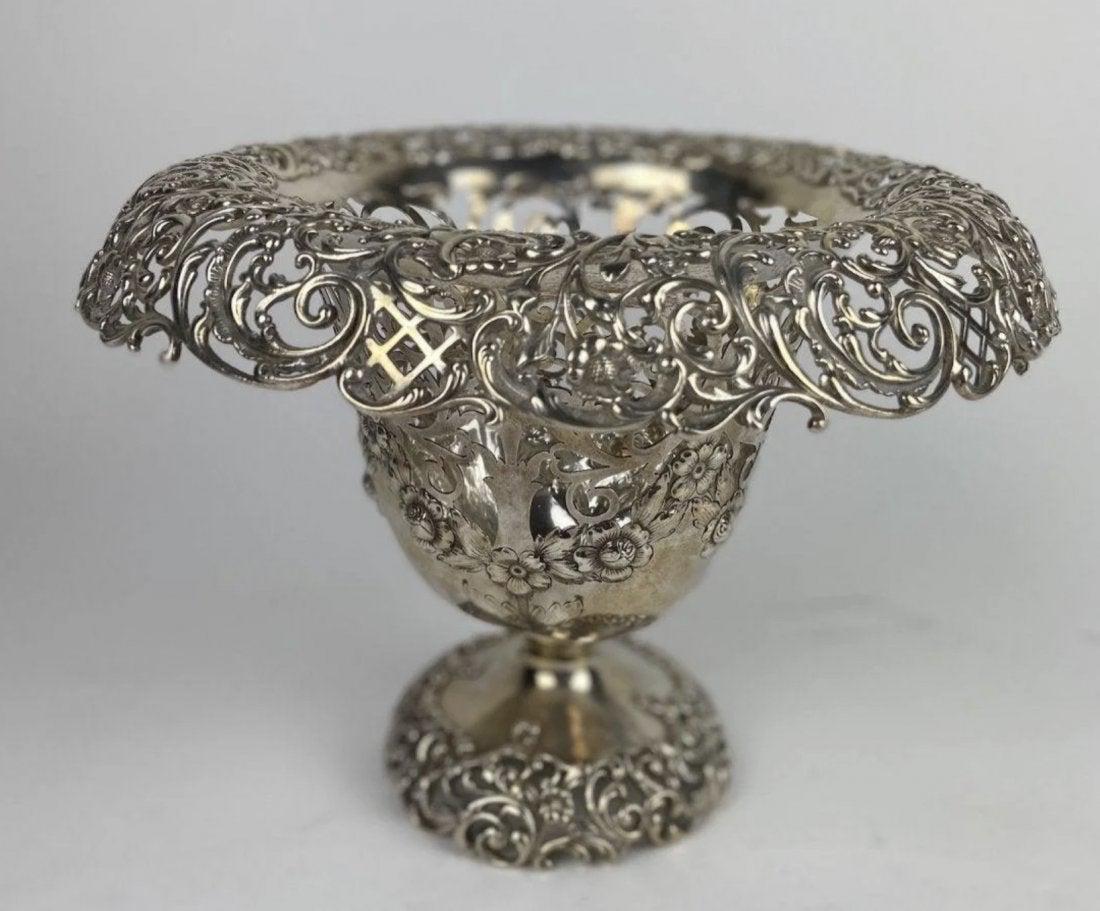 LARGE AMERICAN STERLING SILVER PIERCED CENTERPIECE: by Roger Williams Silver Co., Providence, RI, circa 1900-1913, retailed by The Cowell & Hubbard Co. Everted and reticulated rim with domed and reticulated base, diameter 11in (28cm), silver weight app
