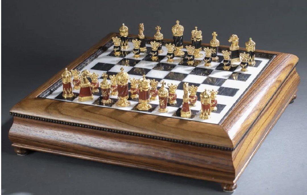 IMPERIAL FABERGE 24KT GOLD OVER SILVER CHESS SET: Faberge Imperial Jewled chess set by Igor Carl Faberge. Board constructed of polished marble set in rosewood. Playing pieces crafted in jasper, onyx and 24k gold over Sterling silver set with rubies,