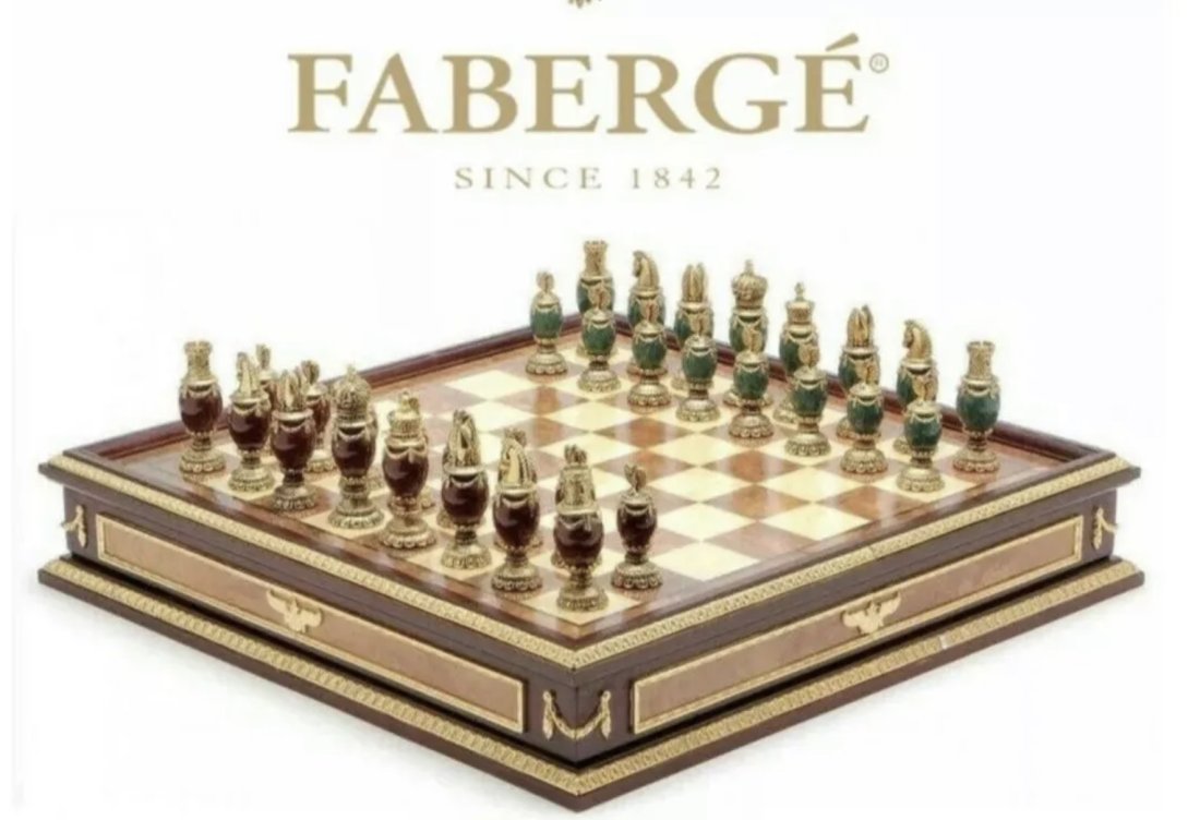 IMPERIAL FABERGE CHESS SET: consisting of green and burgundy jeweled body chess set with 24k gold plated headpieces, inspired by the jeweled eggs of Faberge, produced by the Franklin Mint and designed by The House of Faberge, ho