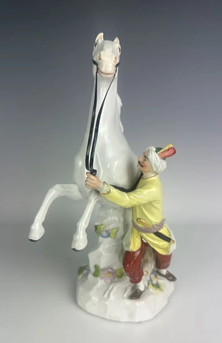 19TH C. MEISSEN GROUP OF MAN AND A HORSE: First quality cross swords mark. Measures 11 inches high. In good antique condition. Estimate $1.500-2.000