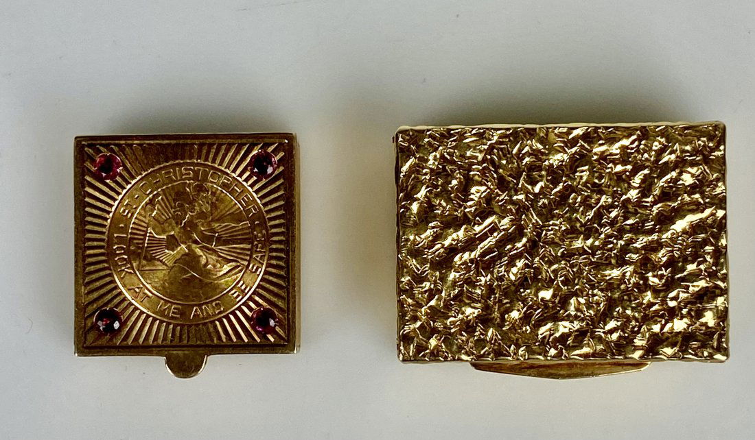 SET OF TWO 14KT GOLD PILL BOXS: One inset with a coin of St. Christopher gold coin and Ruby. Estimate $1.500-2.000