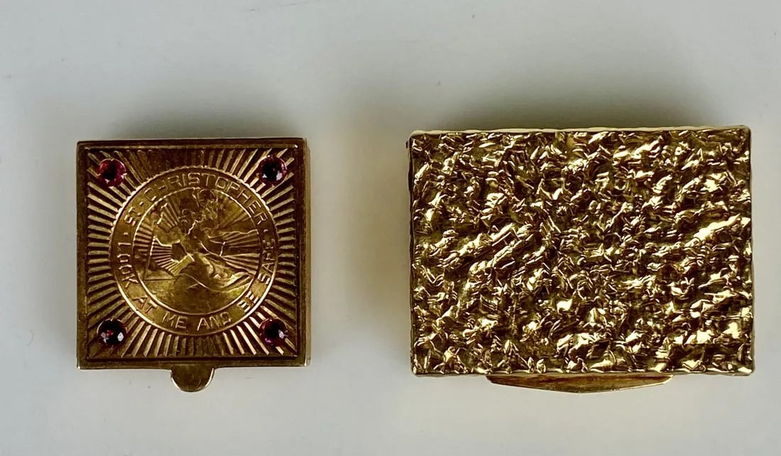 SET OF TWO 14KT GOLD PILL BOXS: One inset with a coin of St. Christopher gold coin and Ruby. Estimate $1.500-2.000