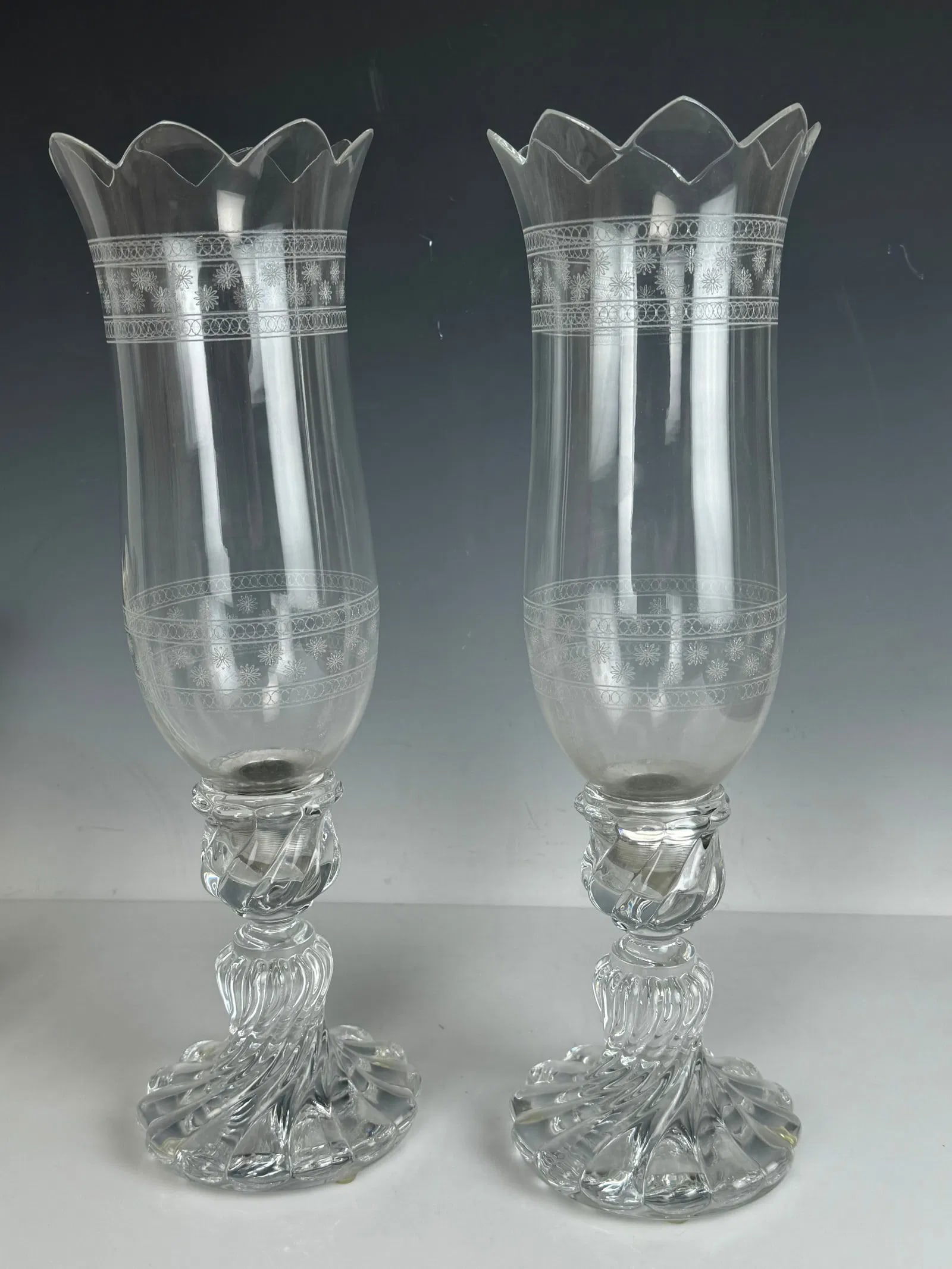A PAIR OF SIGNED BACCARAT HURRICANE LAMPS: Measures 16 inches high. In excellent condition. Both bases stamped Baccarat. Estimate $600-800