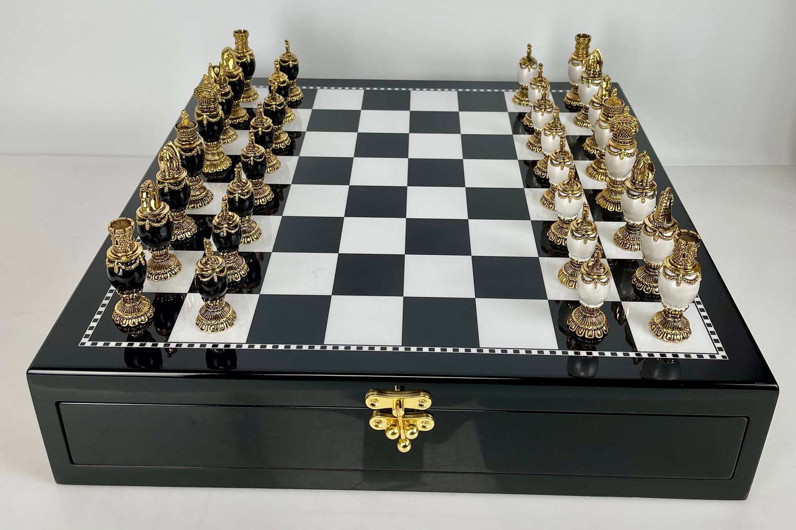 IMPERIAL FABERGE GOLD PLATED AND JEWELLED CHESS SET: The board measures 18” x 18”. Estimate $2500-3000