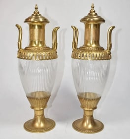 A PAIR OF ORMOLU MOUNTED CUT CRYSTAL VASES AND COVER