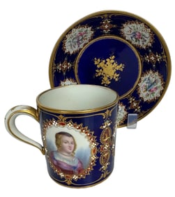A MAGNIFICENT JEWELLED SEVRES CUP AND SAUCER