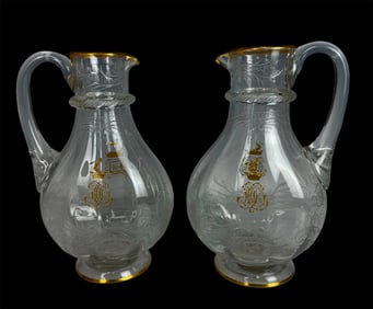 A PAIR OF ETCHED BACCARAT CRYSTAL EWERS