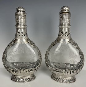 A PAIR OF DUTCH SILVER AND ETCHED GLASS LIQUOR BOTTLES