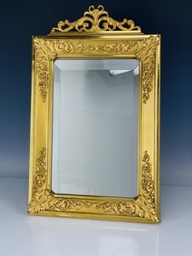 A LARGE ORMOLU MIRROR