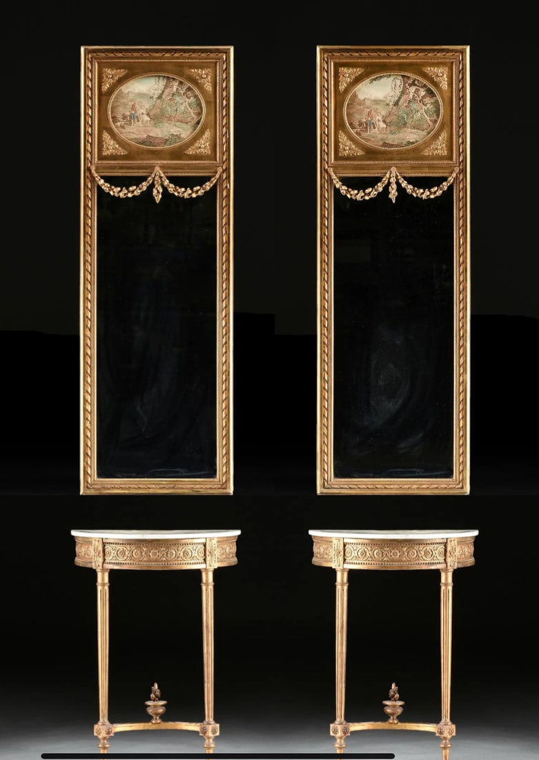 A PAIR OF LOUIS XVI STYLE CONSOLE TABLES WITH TRUMEAU MIRRORS: Circa 1900, gilt demi-lune console tables with marble tops and with accompanying gilt mirrors. Tables: 32 1/4 x 23 1/2 x 12 in. (81.9 x 59.7 x 30.5 cm.), Mirrors: 67 1/4 x 23 in. (170.8 x 58.4 cm.) Es
