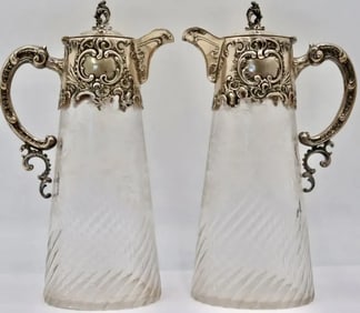 A PAIR OF ANTIQUE CONTINENTAL SILVER AND CRYSTAL PITCHERS