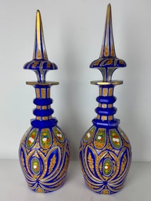 A PAIR OF PERSIAN TASTE BOHEMIAN BOTTLES AND TOPS