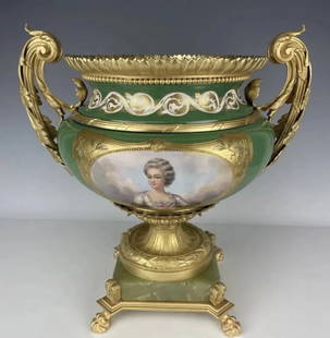 A LARGE ORMOLU MOUNTED SEVRES PORCELAIN CENTREPIECE: Circa 1900. Measures 24 inches Handel to Handel , 18 inches tall. Estimate $2.500-3.000