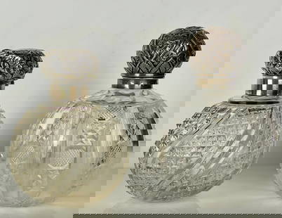 2ENGLISH CUT CRYSTAL AND SILVER PERFUME BOTTLES: Tallest 6.5 inches . Silver hall marks, in good condition. Estimate $400-500