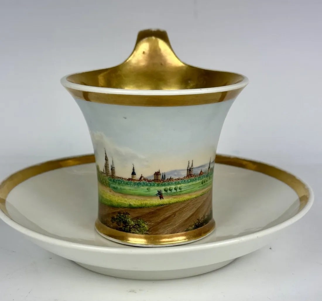 19THC. FURSTENBURG TOPOGRAPHICAL CUP AND SAUCER: In good condition, minor loss of gold. Estimate $600-800