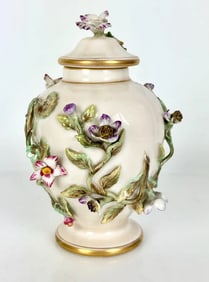 A FLOWER ENCRUSTED BERLIN KPM BOTTLE AND COVER
