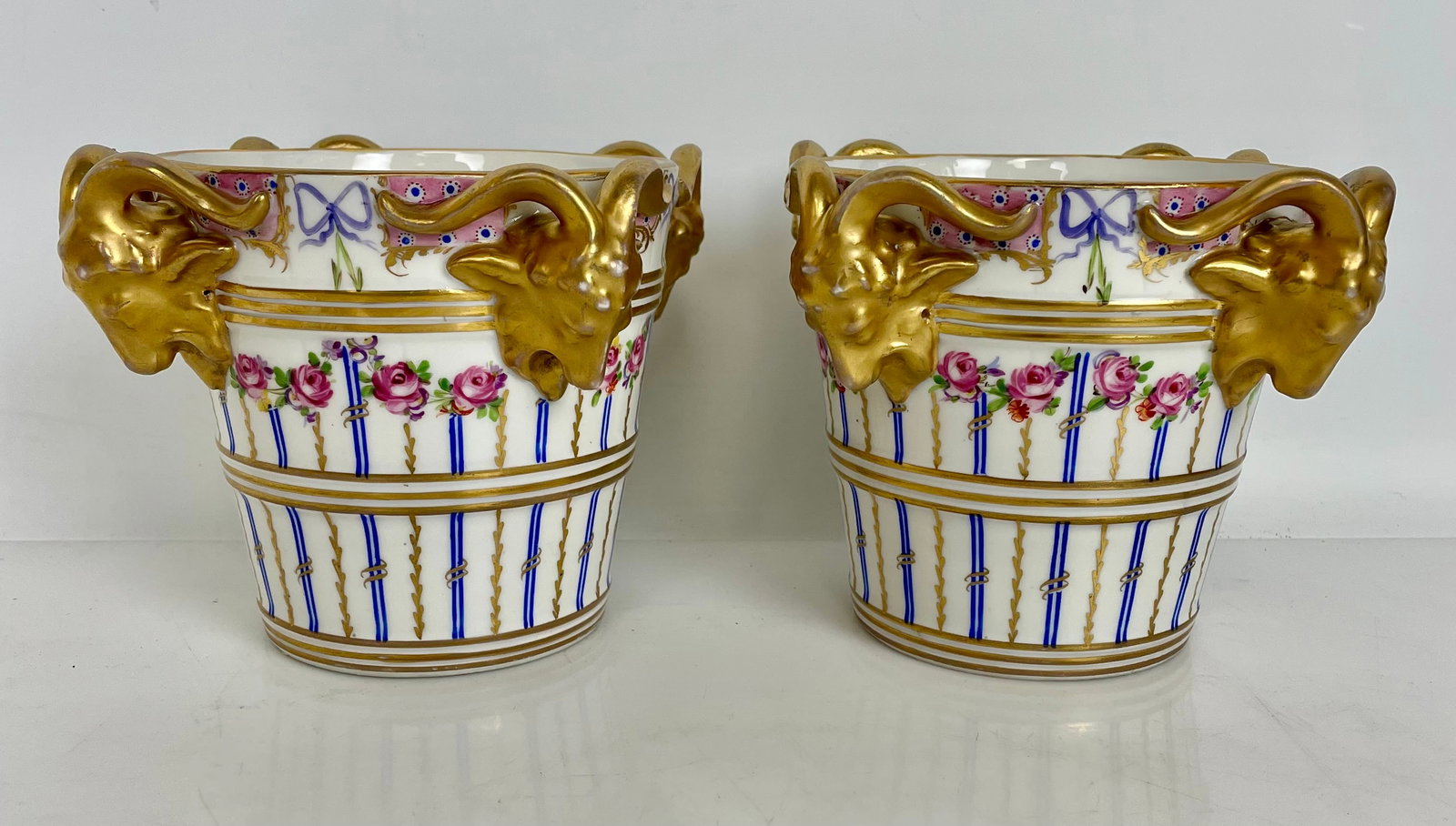 A PAIR OF ROYAL VIENNA PLANTERS: Circa 1900. Measures 4.5” high. Estimate $300-400