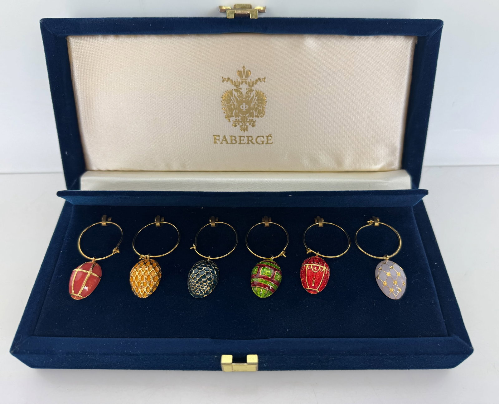 IMPERIAL FABERGE ENAMEL CHARMS: In original presentation box. Estimate $500-600